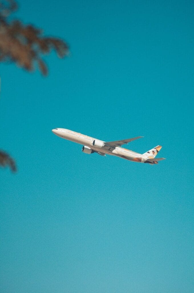 white airplane flying in the sky during daytime