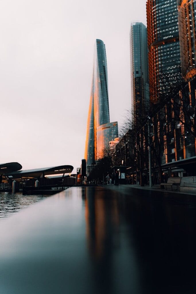 Modern skyscrapers reflected in water at dusk